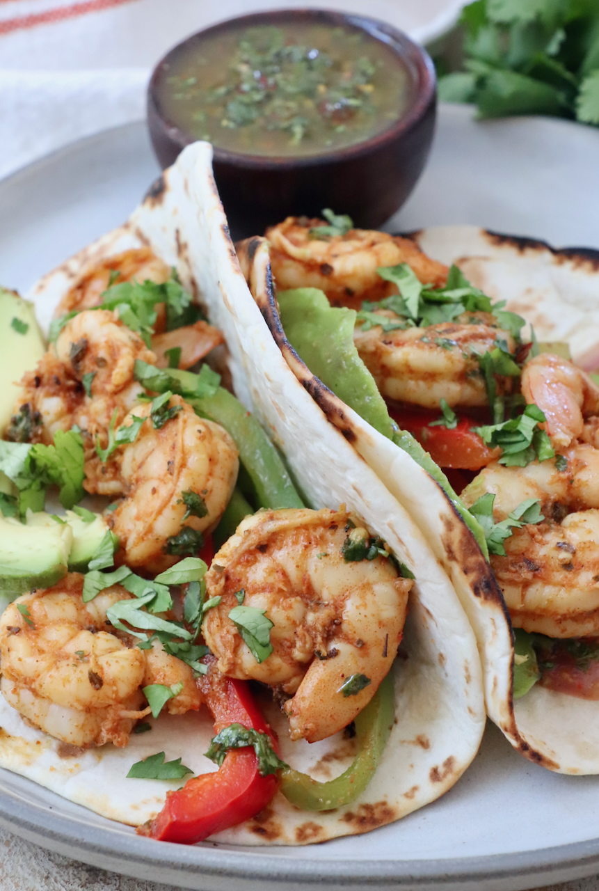 shrimp fajitas in tortillas on a plate