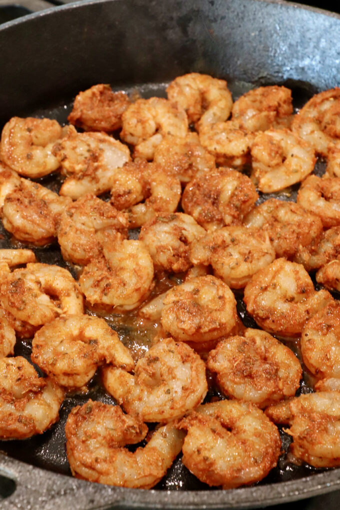 seasoned raw shrimp in a cast iron skillet