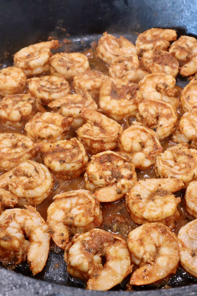 seasoned cooked shrimp in a cast iron skillet