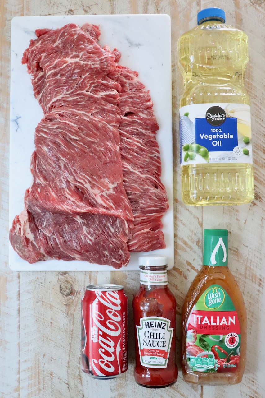 ingredients for steak tips on a white wood board