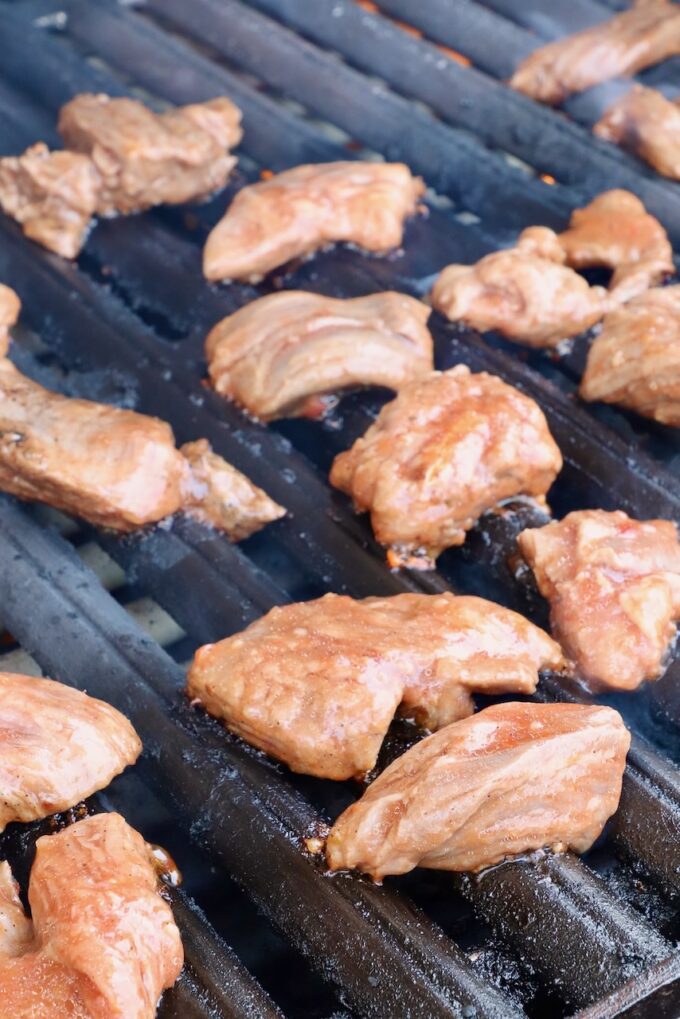 marinated raw steak tips on a grill