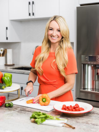 woman standing at kitchen counter slicing vegetables