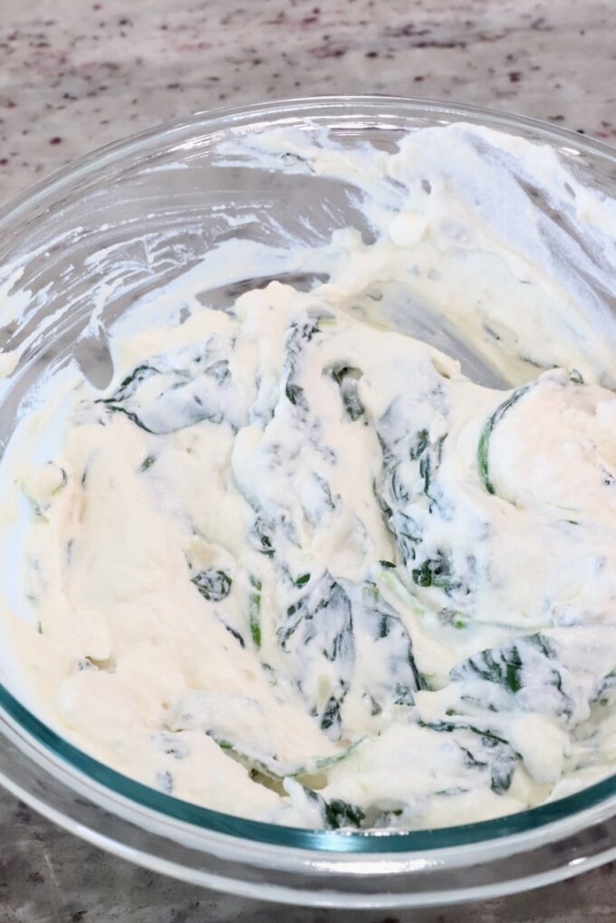 ricotta cheese mixed with spinach in a glass bowl