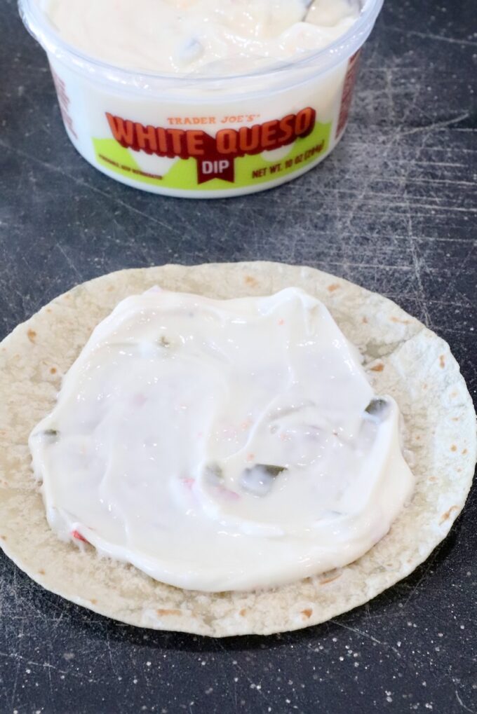 queso dip spread on a tortilla