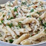 cooked penne pasta in a creamy sauce in a bowl