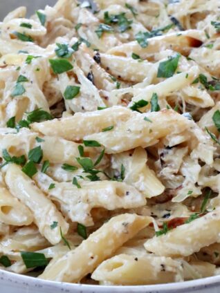 cooked penne pasta in a creamy sauce in a bowl