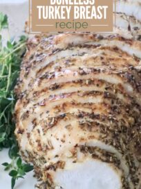 Sliced boneless turkey breast sprinkled with herbs, displayed on a white platter with fresh thyme. Overlay text reads "Easy Air Fryer Boneless Turkey Breast Recipe."
