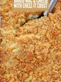 Baked mac and cheese with a golden Cheez-It crust, featuring a serving spoon lifting a portion. Text overlay reads, "Thanksgiving Side. Baked Mac & Cheese with Cheez-It Crust"