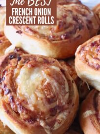 Close-up of golden-brown French onion crescent rolls, topped with melted cheese, arranged in an appetizing stack. Text overlay reads "The Best French Onion Crescent Rolls."