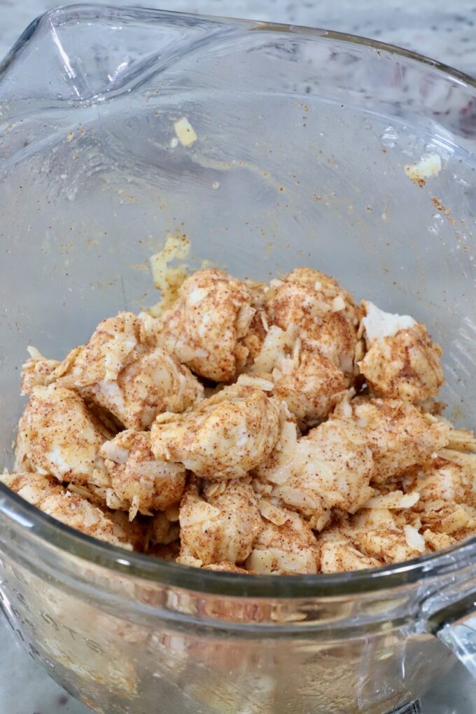 seasoned cubes of uncooked biscuit dough in a glass bowl