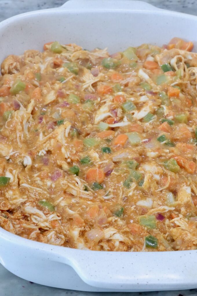 buffalo chicken pot pie filling in a baking dish