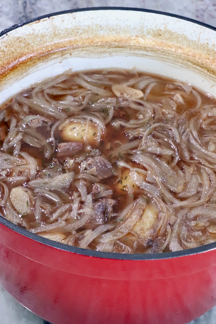 cooked french onion beef stew in a pot on a countertop
