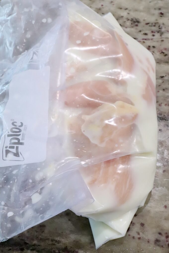 pieces of chicken in a plastic bag with a buttermilk brine