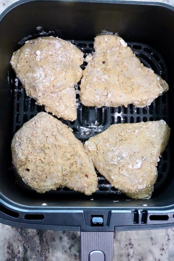 breaded chicken in an air fryer basket