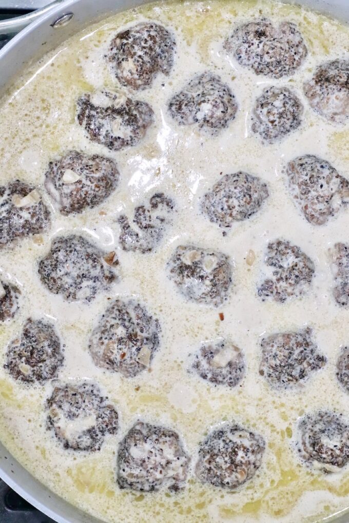 meatballs in a pan sauce in a skillet