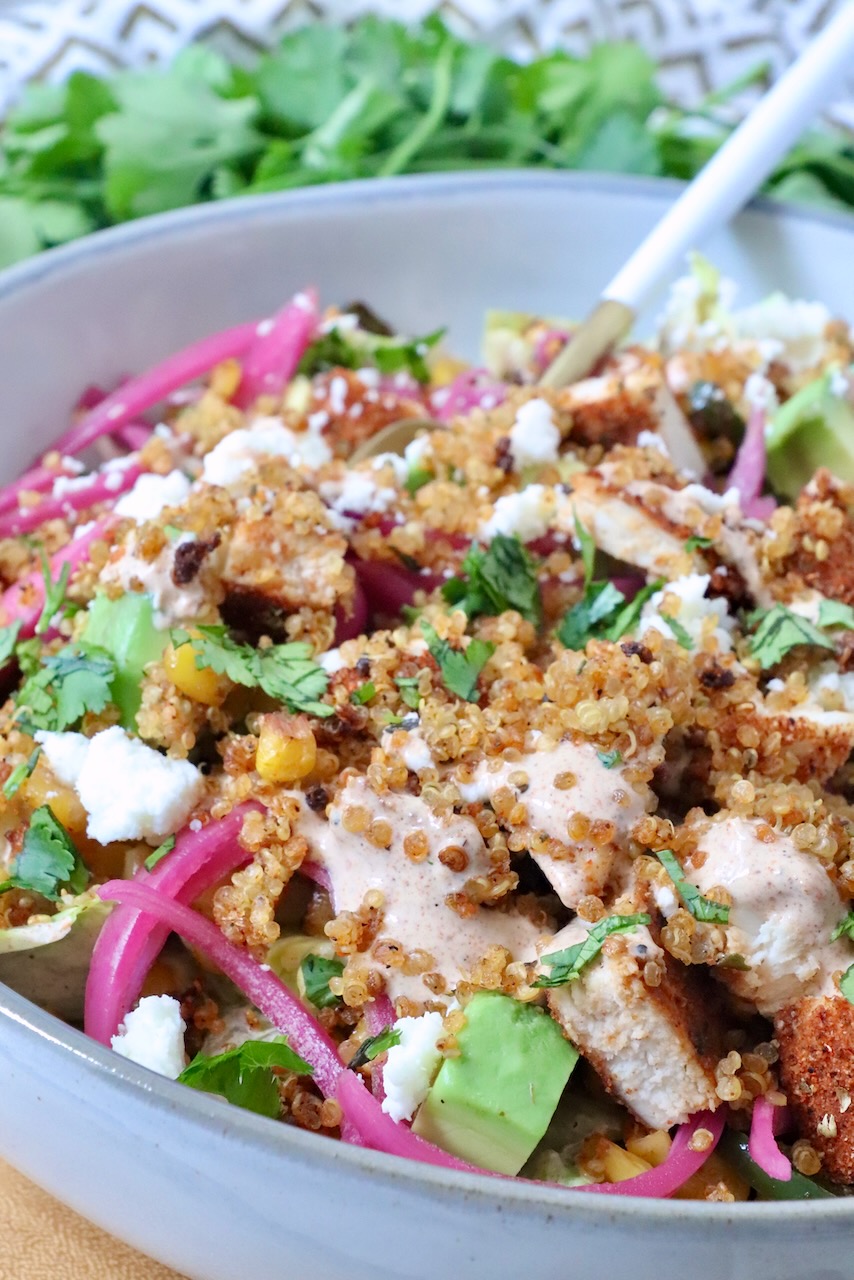 Mexican street corn bowls with cooked chicken, crispy quinoa, and pickled onions
