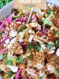 A vibrant bowl of Mexican street corn crispy quinoa chicken salad with avocado, pickled onions, and crumbled cheese, garnished with fresh cilantro.